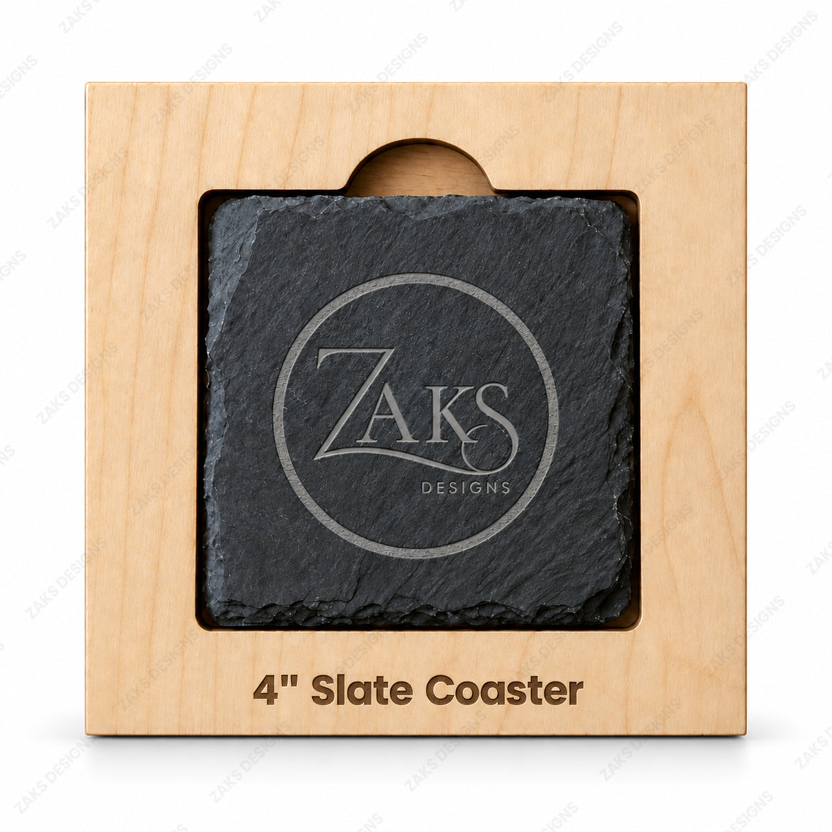 A 4-inch slate coaster with a circular Zaks Designs logo, presented in a light natural wood display box with a cutout window.
