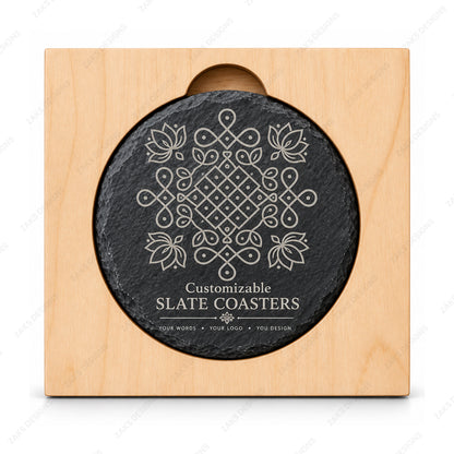 A round black slate coaster with a white engraved geometric floral pattern and the text 'Customizable SLATE COASTERS' at the bottom, mounted on a square light wood display block against a white background.