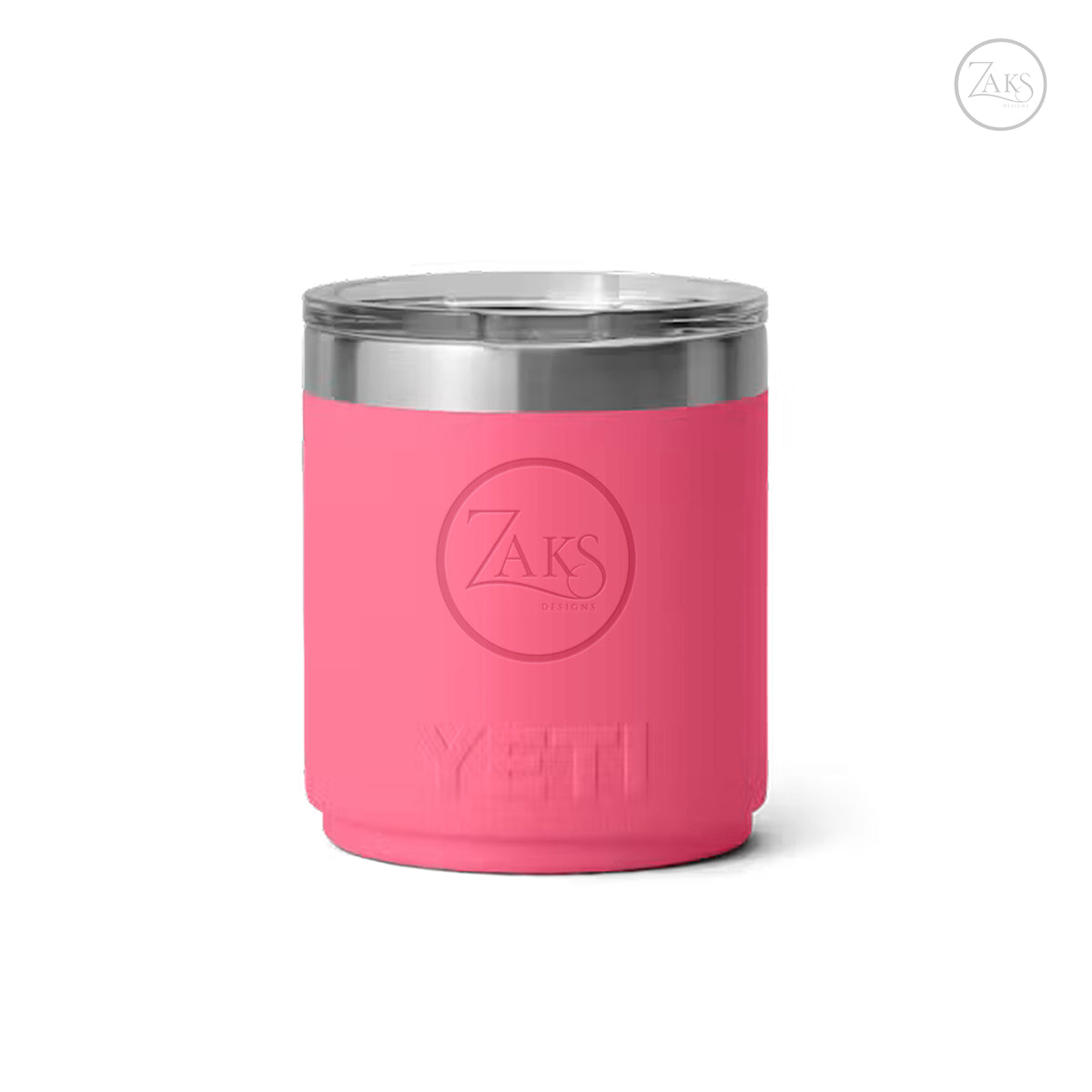 A pink YETI insulated tumbler with a stainless steel rim and a clear lid, featuring an embossed ZAKS logo on the front, set against a plain white background.
